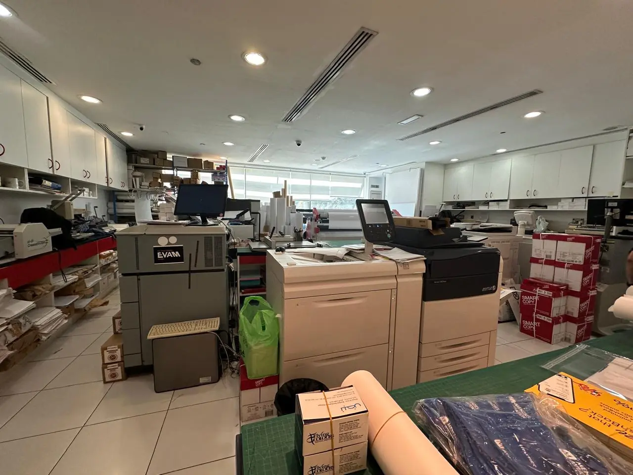 The print floor at Flying Colours, Dubai Media City: production printers, paper stock and finishing benches